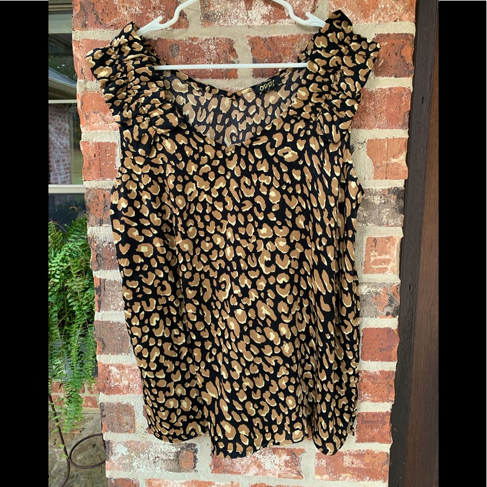 Cute silky sleeveless top with ruffle detail on shoulders.